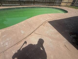 The soil beneath the homeowner's concrete pool deck had gradually eroded and settled, causing the concrete to sink and crack.