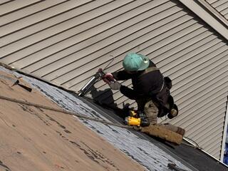 Installing Step Flashing Along the Roof-to-Wall Connection