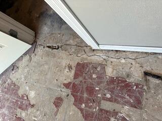 Cracked Concrete at a Doorway Before Repair