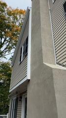 Complete exterior chimney stucco resurfacing and weatherproofing application.