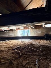 Exposed Soil and Debris Before Crawl Space Improvements