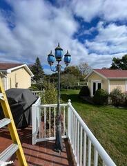 Before: Faded, weathered outdoor lamp post in need of professional restoration and repainting