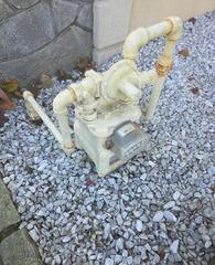 Weather-damaged gas meter exhibiting surface rust and peeling paint prior to treatment.