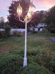 After: Beautifully refinished outdoor lantern post post-restoration.