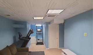 After: Vibrant blue accent walls creating a modern, cohesive look throughout the entire basement.
