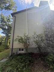 Exterior Radon Piping Near Chimney