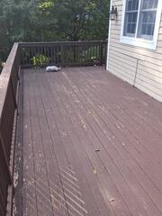 Worn, peeling, and sun-damaged wood decking before prep and power washing.