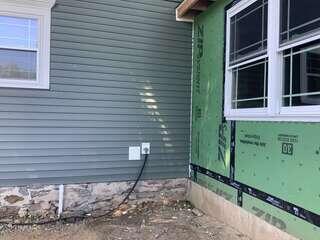 Exterior Piping Along the Fieldstone Foundation