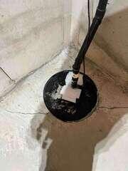 Covered Sump Pump and Pipe Connection