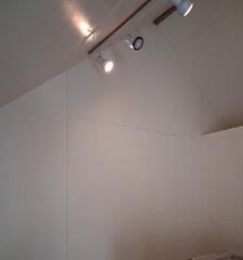 Seamless wall surface preparation and smooth paint application on vaulted accent walls under direct lighting