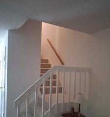 Flawless white paint application on interior stair railings and high-traffic entryways