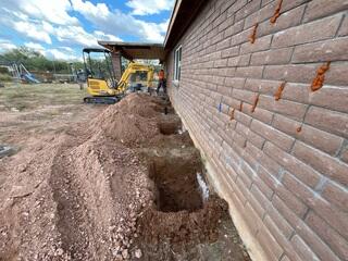 Crew Installing Foundation Support Piers