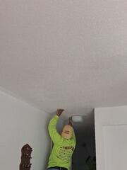 Precise ceiling edge cutting and joint compound touch-ups around fixture entryways