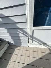 Water infiltration and deteriorating trim gap adjacent to the exterior composite deck.