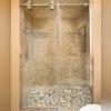 There is a lally column that we hid in the shower wall to the left.  From that point, we could determine the size the shower would be when tucked in that area, which is why the base needed to be customized first.  The shower door, custom made to the exact dimensions of the shower, is a sliding door...
