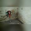 To start a trench is jackhammered away from the basement walls.