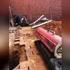 The soil along the foundations edge are removed to install hydraulic driven piers to load bearing soil.  This is a picture of Eric working hard to keep piers driving as well as keeping warm!