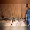 As moisture has seeped into the basement, it has been absorbed by the wood paneling causing it to warp and chip.