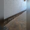 Weep holes are drilled into the brick to relieve pressure that the built up water inside has created.