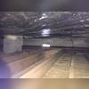 Air carrying moisture is flowing into the crawl space through open vents, the porous cinderblock wall, and from the earth. The damp air is trapped in the crawl space, raising the relative humidity, and is pulled up into the home.