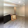 Gray faux-wood flooring was installed. This flooring has the attractive look of real wood, but is actually made with inorganic materials making it water-resistant and moldproof.