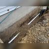 Once we made sure that our piping was level we  poured a small amount of gravel throughout the entirety of the piping in order to stake it and make sure that it would not move before we laid gravel over the entirety of the system, as well as backfilled.