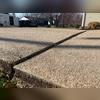Settlement in the driveway has caused separation at the joints between the concrete slabs.