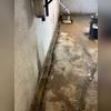This photo shows after the crew prepared the perimeter of the home for the WaterGuard and sump pump. As you can see the crew has installed the sump pump and they have installed the outside discharge.
