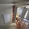 The crew cut a strip in the garage ceiling to install new insulation.