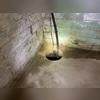 A view of the old sump pump pit. You can see where water is seeping from the cove joint, which is where the wall and floor meet.