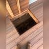 The workers find the entrance to the crawlspace under the deck.