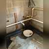 When installing the dewatering system, weep holes are drilled in the hollow cores of the concrete cinderblocks, the system is then installed flush with the top of the concrete footing, and a bed of stone is installed and finally the floor mortared back together.