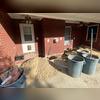 Holes were excavated to install helical piers under the foundation wall.