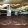 Under the vapor barrier is a drainage matting layer that aids water drainage and acts as a "matting" to help protect the barrier from tears that could allow water or moisture in.