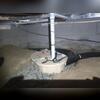 The drain line and sump pump are being installed before the new vapor barrier can be laid down. The trenching will be filled with more drainage rock to ensure water can move freely toward the sump pump without clogging the system.