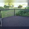 New Regal railing in bronze was added and then the dark outdoor grass carpeting installed to protect the rubber roof for the new outdoor space