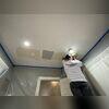 Technician secures the drywall patches.
