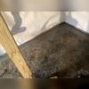 Concrete is chipped out along the border of the foundation to make space for WaterGuard to be installed. This system takes water from the outside wet soil and filters it to the sump pump, without ever being exposed to the basement walls or floor.
