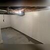 The back of these wall panels have a foil vapor barrier that tucks into the subfloor drains under the ground.