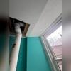 The PVC pipe exits through the home's siding.