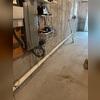We initiated the project by creating an extraction point through the basement floor to depressurize the radon gas beneath the slab. A PVC pipe was then installed at the extraction point to safely channel radon gas away from the home's foundation.