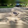 Prior to the PolyLevel work on this Cedar Rapids driveway, the problem was clear. The concrete slabs around the drain had settled significantly, resulting in a large and uneven area in the driveways middle, impacting both safety and the home's value.