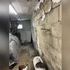 Cracked and bowing foundation wall + no drainage or protection.