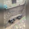 Two helical piers were drilled deep into stable soil to provide lasting support to the chimney structure.