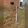Water from the sump pump is carried through this discharge pipe and directed several feet away from the home using a LawnScape outlet, ensuring it doesn't drain near the foundation.