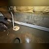 Crew member Julian smooths the concrete out to seamlessly blend the system into the floor!