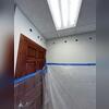 Installers drill small holes between studs in order to access each wall cavity.