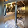 SmartJack support post installed to stabilize sagging floor, with CleanSpace vapor barrier and SmartSump system visible in the background.