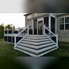 This composite deck features beautiful wrap-around corner stairs and integrated lighting that highlight the craftsmanship and attention to detail.