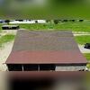Completed barn roof project with architectural shingles and corrugated metal, installed safely on a live agricultural site with zero impact to animals or daily operations.